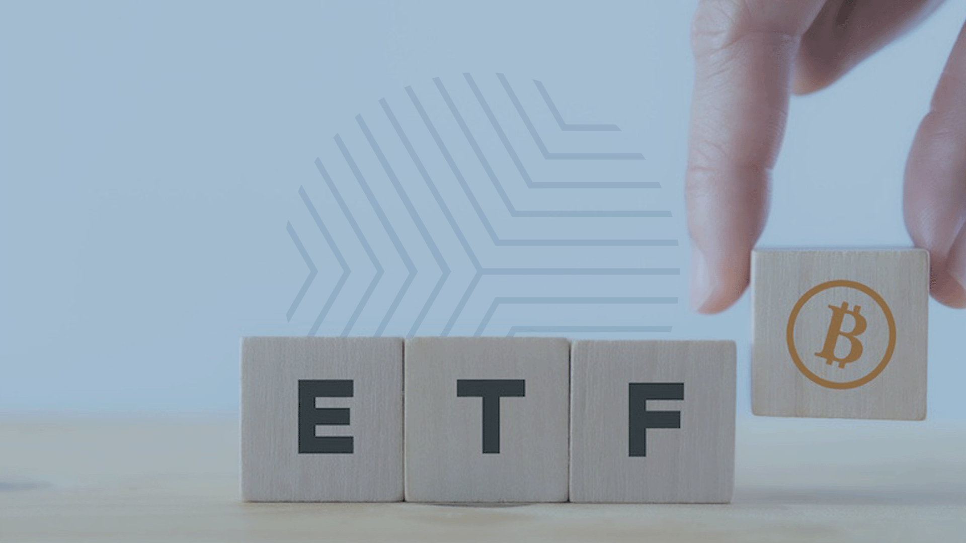Hand placing the last cube with a Bitcoin symbol on it next to cubes spelling out 'ETF', representing the potential impact of a Bitcoin spot ETF on market performance.